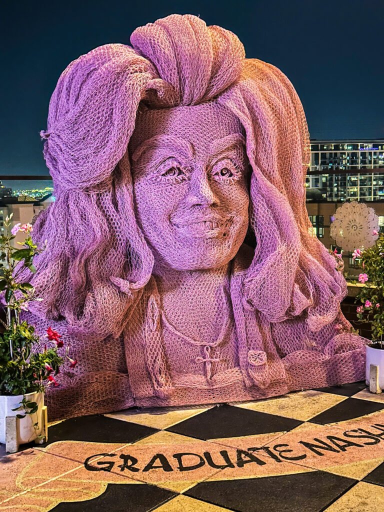 Pink Dolly Parton statue on the rooftop of The Graduate Nashville hotel