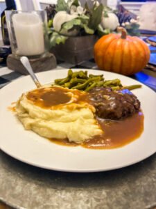 Plate of Homestyle Salisbury Steak with mashed potatoes and green beans